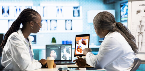 Medical office scene of a doctor and patient evaluating cardiology test results
